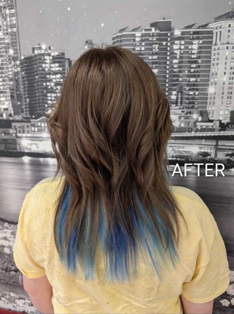 Back view of layered brunette hair with vivid blue peekaboo ends